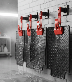 Rocket Science Alliance TT40 Mat Clamps shown in black with metal handles, used for holding mats securely in place.